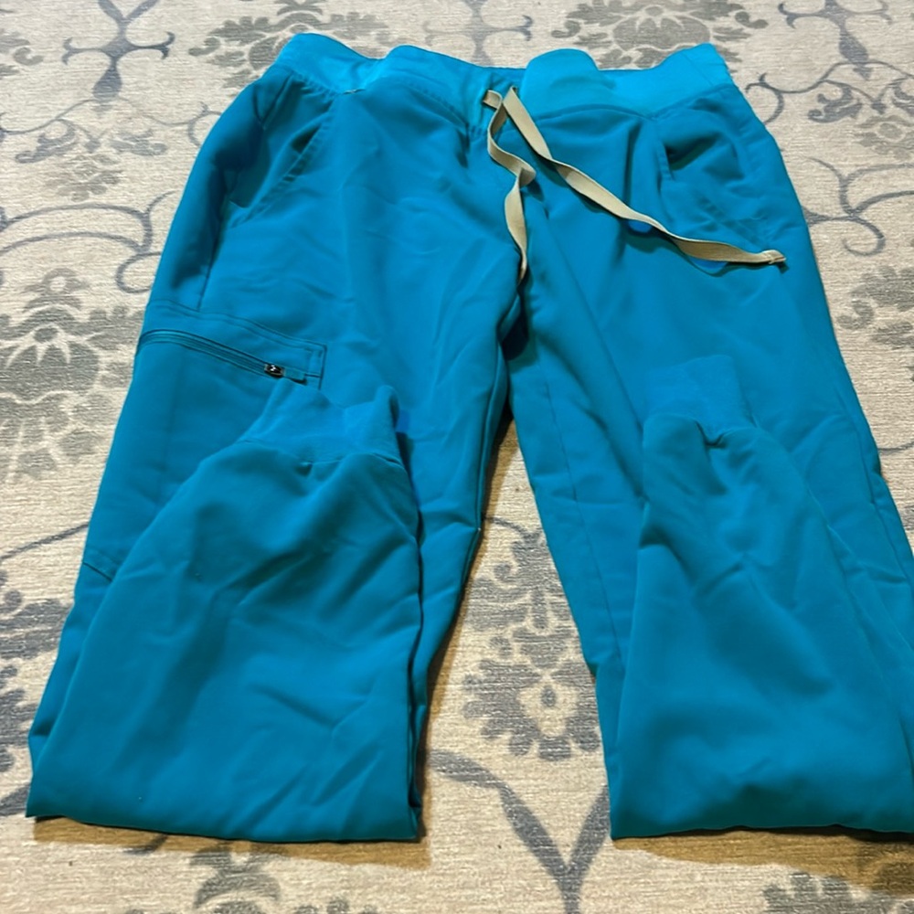 Figs scrubs in teal barley worn